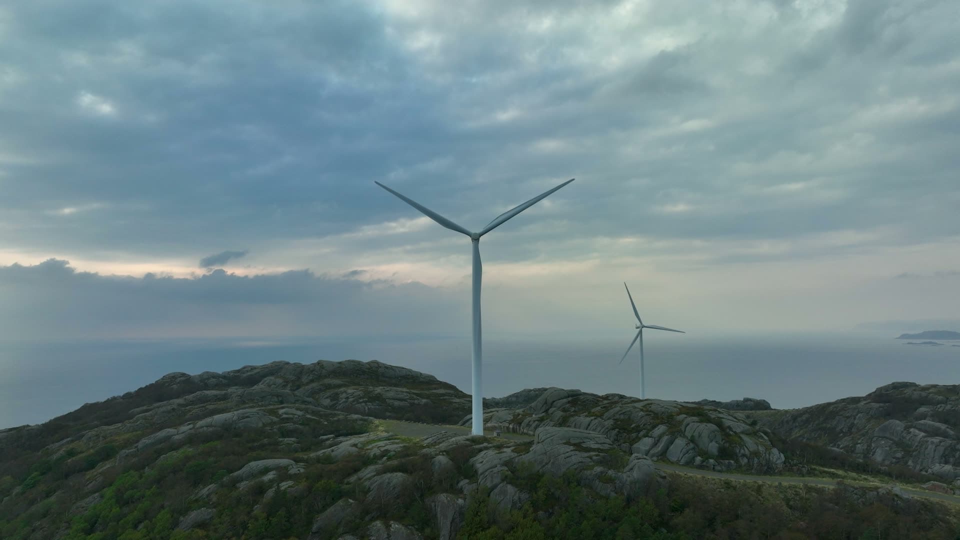 Two wind turbines on bare rocky ridge, Lista, Norway