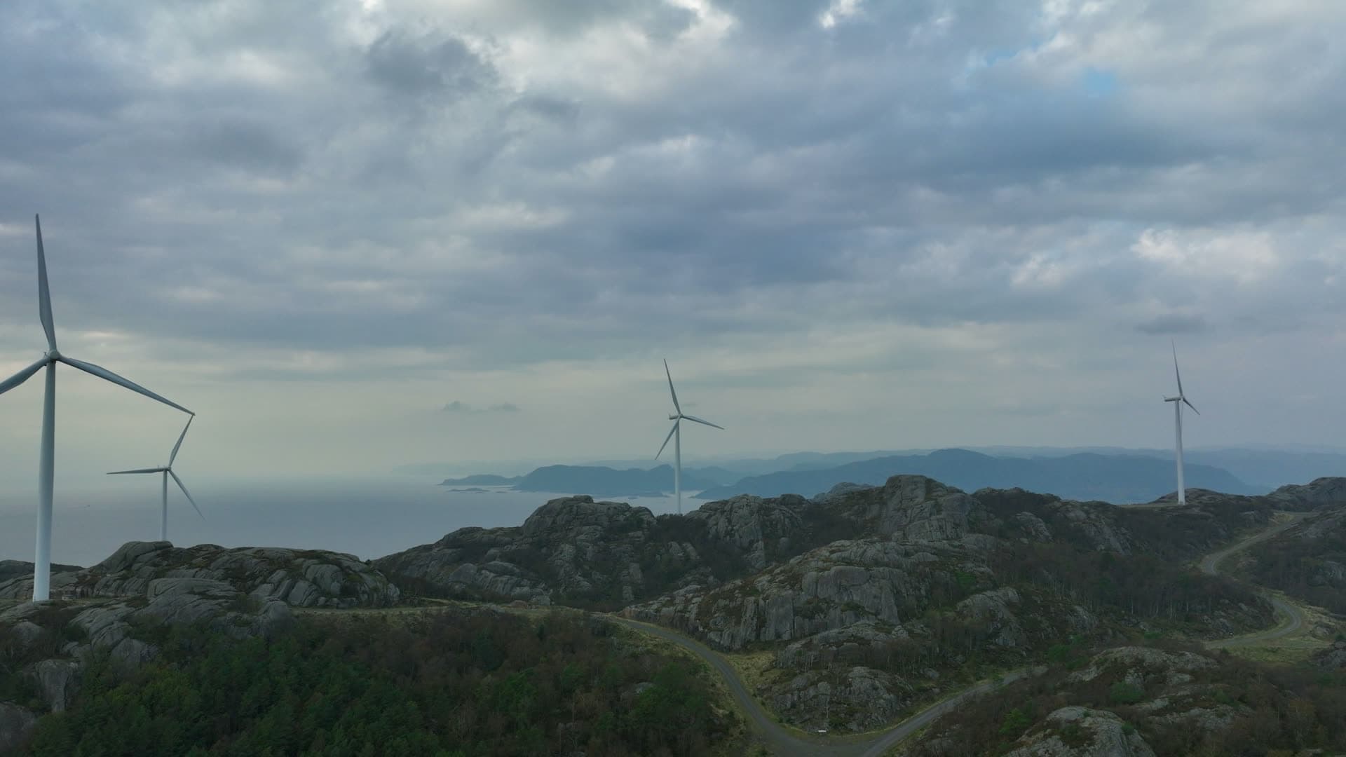 Wind turbines on rocky ridge above sea, Lista, Norway