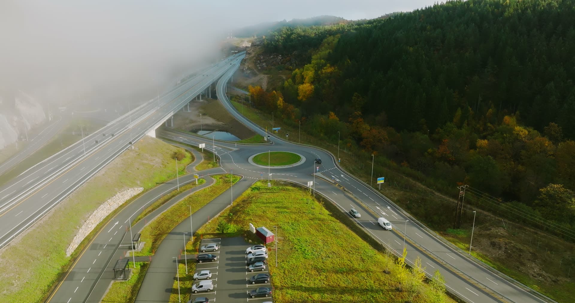 Fog rolling over motorway roundabout, Monan, Norway