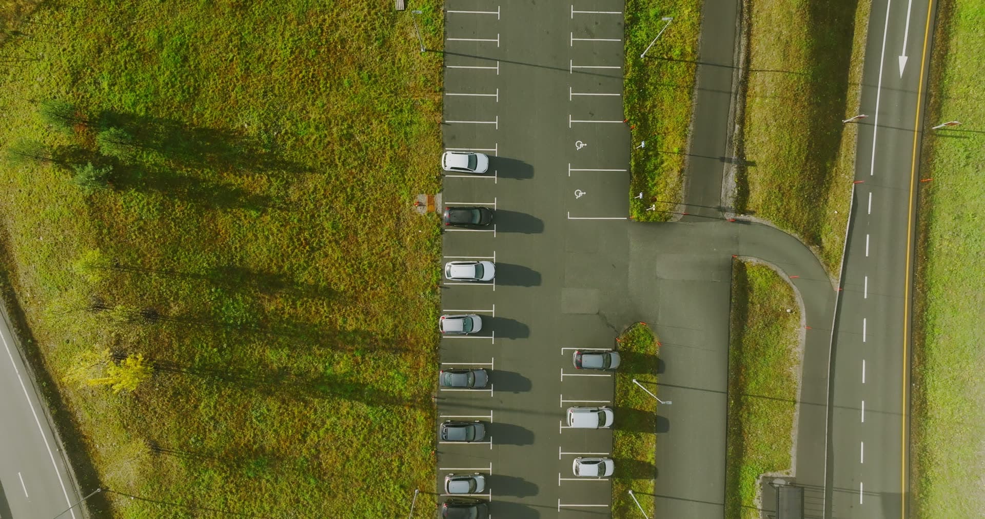 Top-down over park-and-ride lot by highway, Monan, Norway