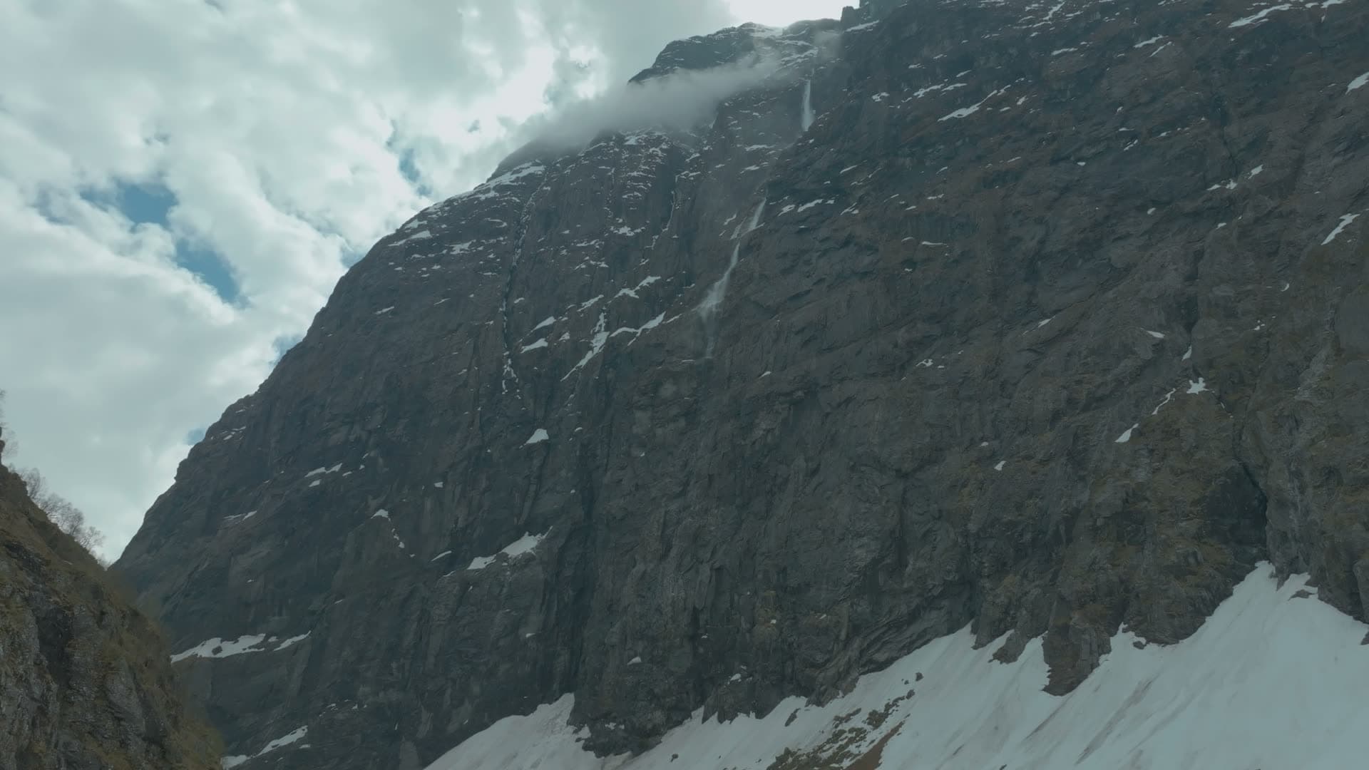 Cloud spilling over sheer cliff face, Norangsdalen, Norway