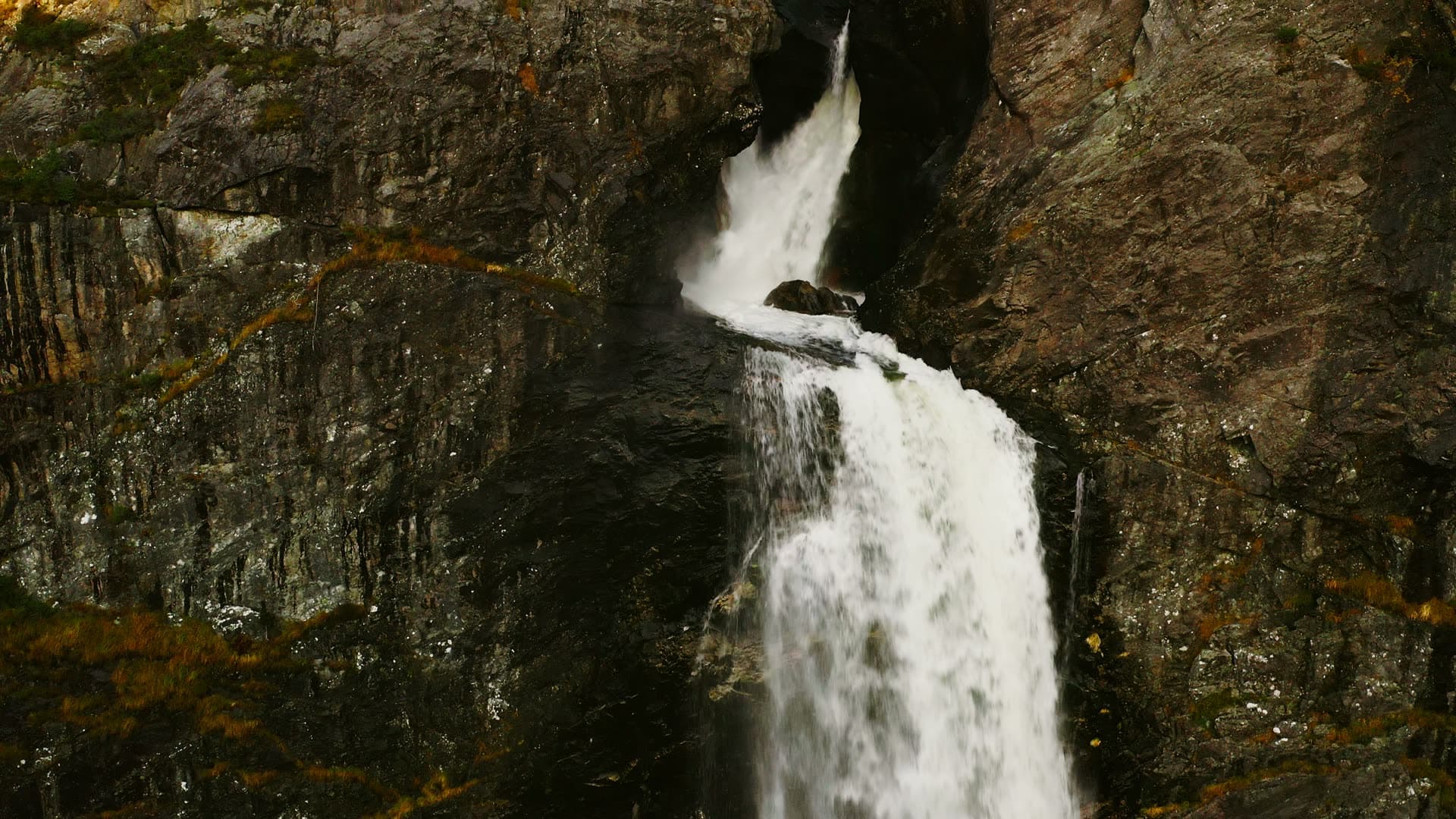 Waterfall dropping through narrow rock cleft, Månafossen, Norway