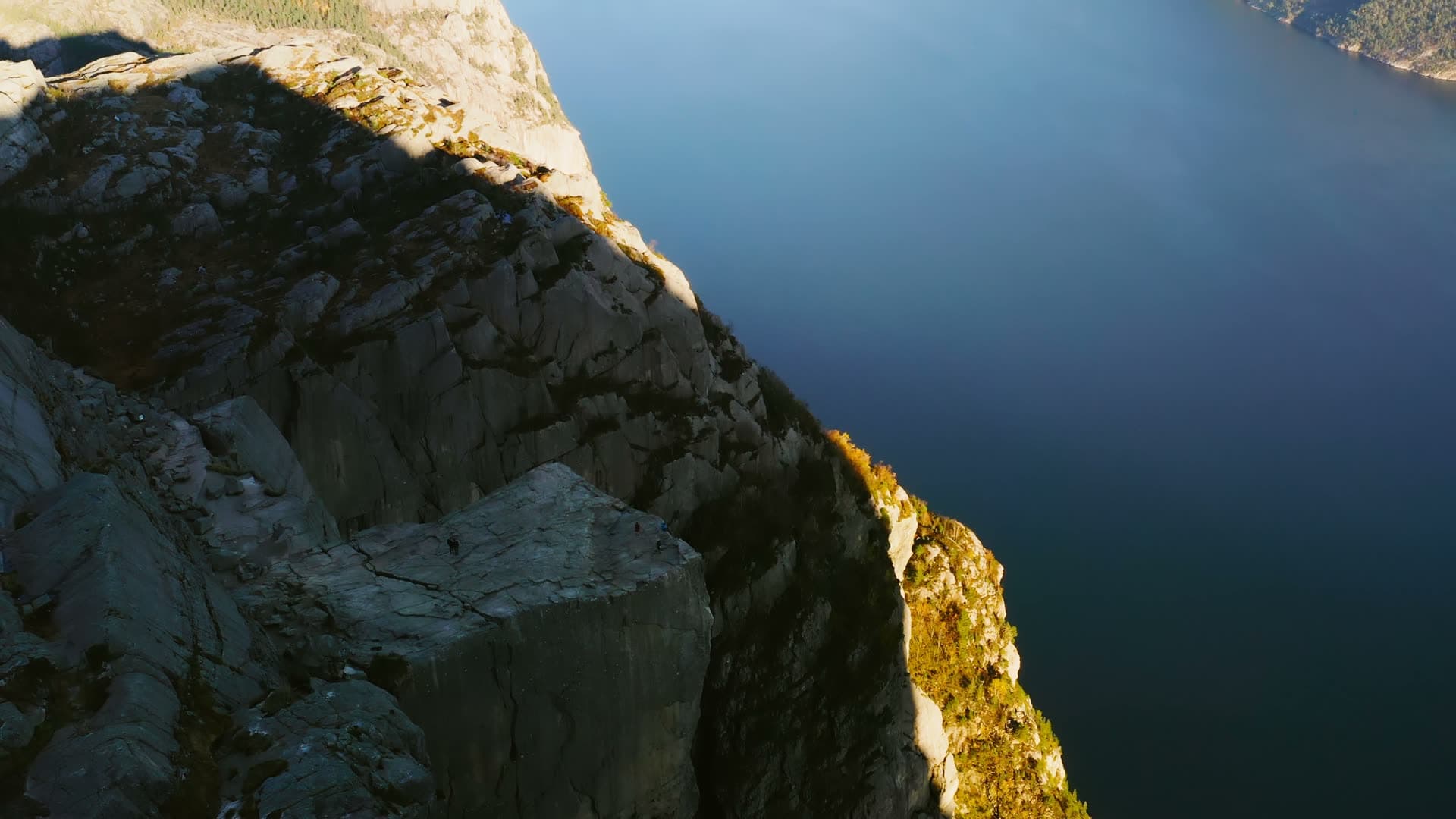 Cliff edge above deep fjord water, Preikestolen, Norway