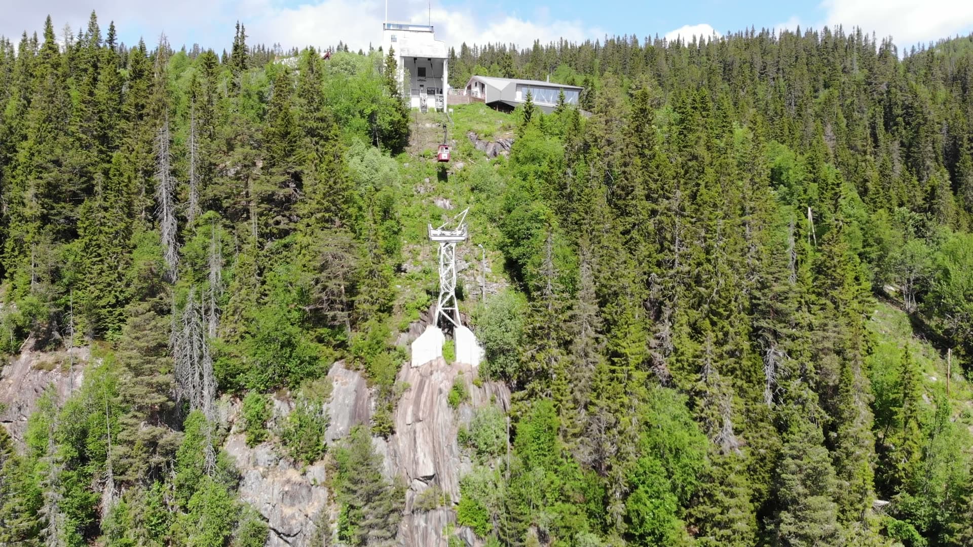 Cable car pylon and hilltop station in spruce forest, Rjukan, Norway