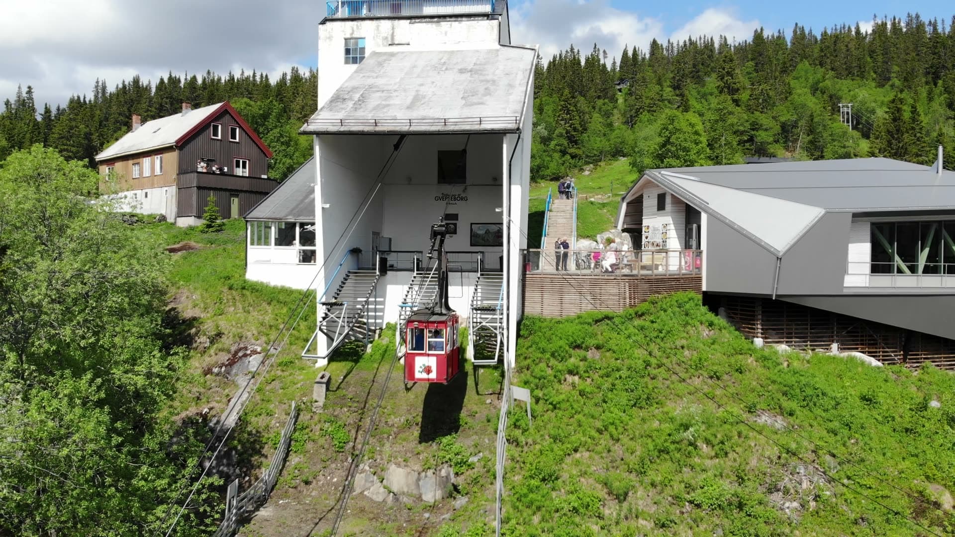 Red cable car docked at hilltop station, Rjukan, Norway