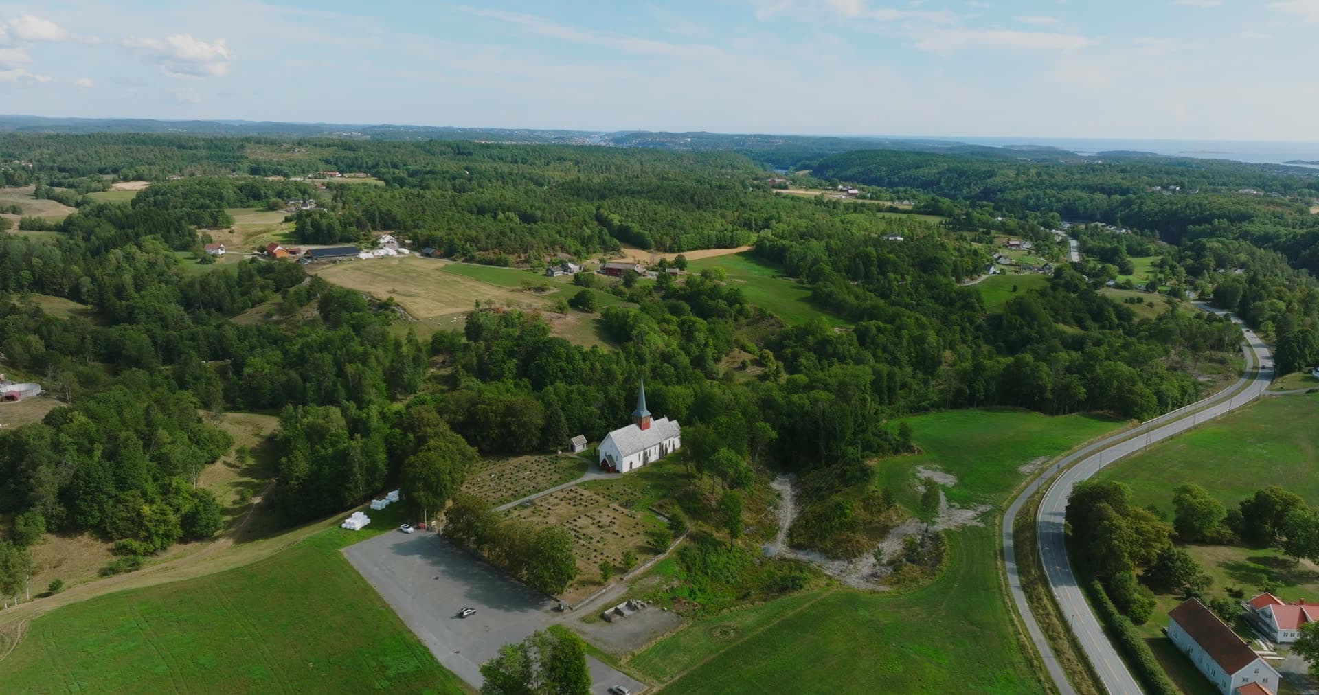Farmsteads and forest ridges toward the sea, Rykene, Norway