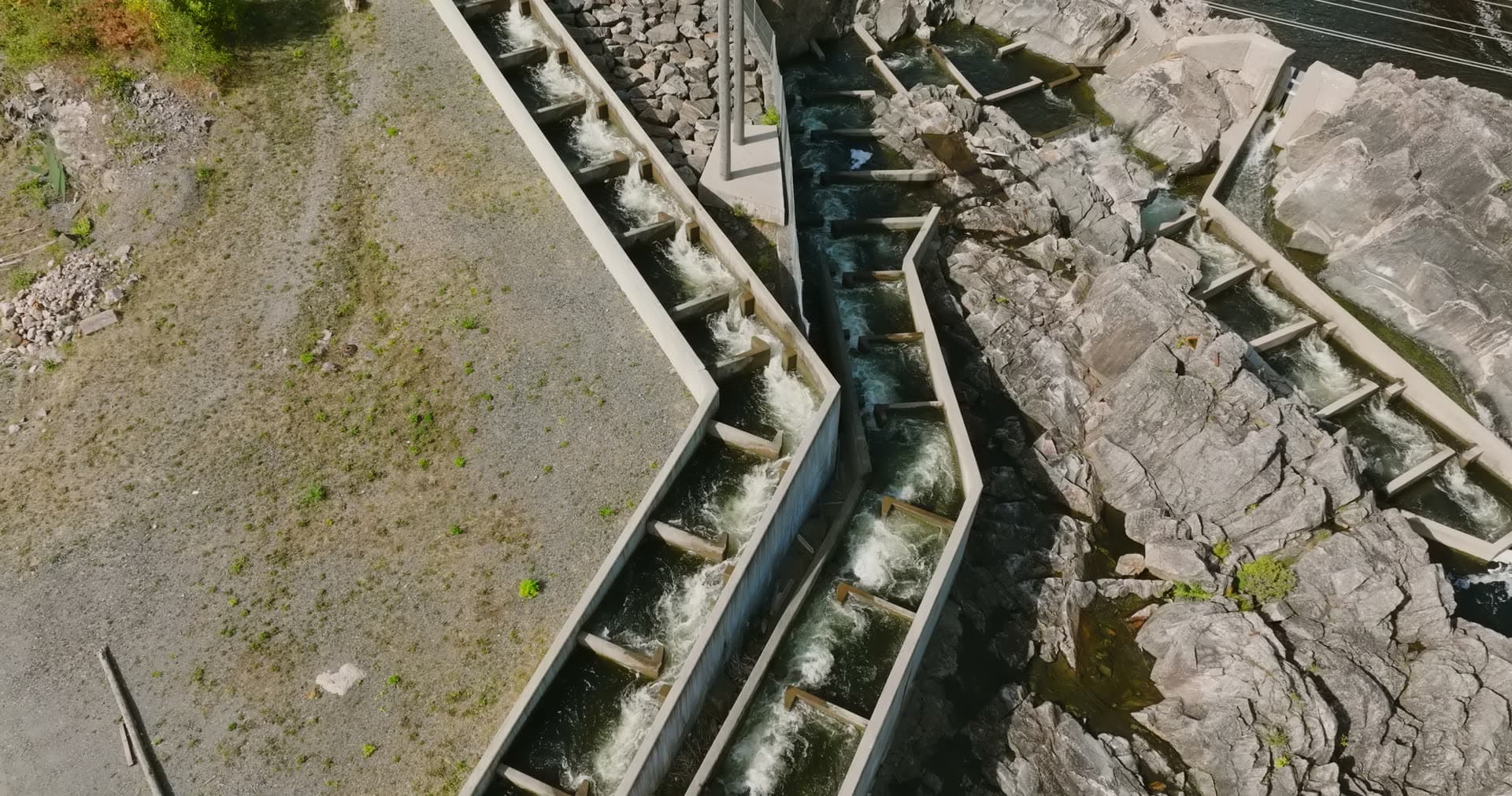 Concrete salmon ladder beside rocky river, Rykene, Norway