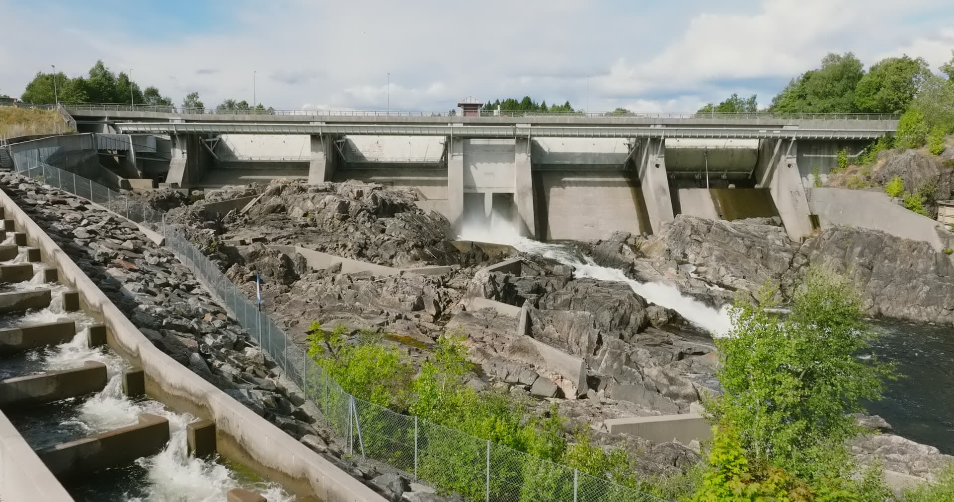 Concrete dam with fish ladder on bedrock, Rykene, Norway