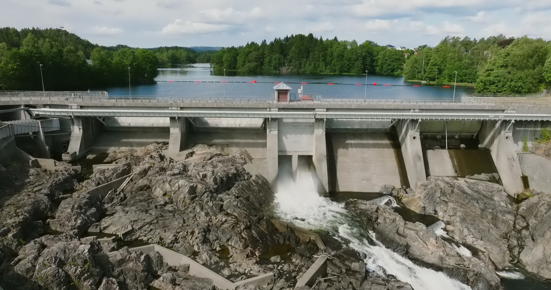 Concrete dam spillway over bare rock, Rykene, Norway
