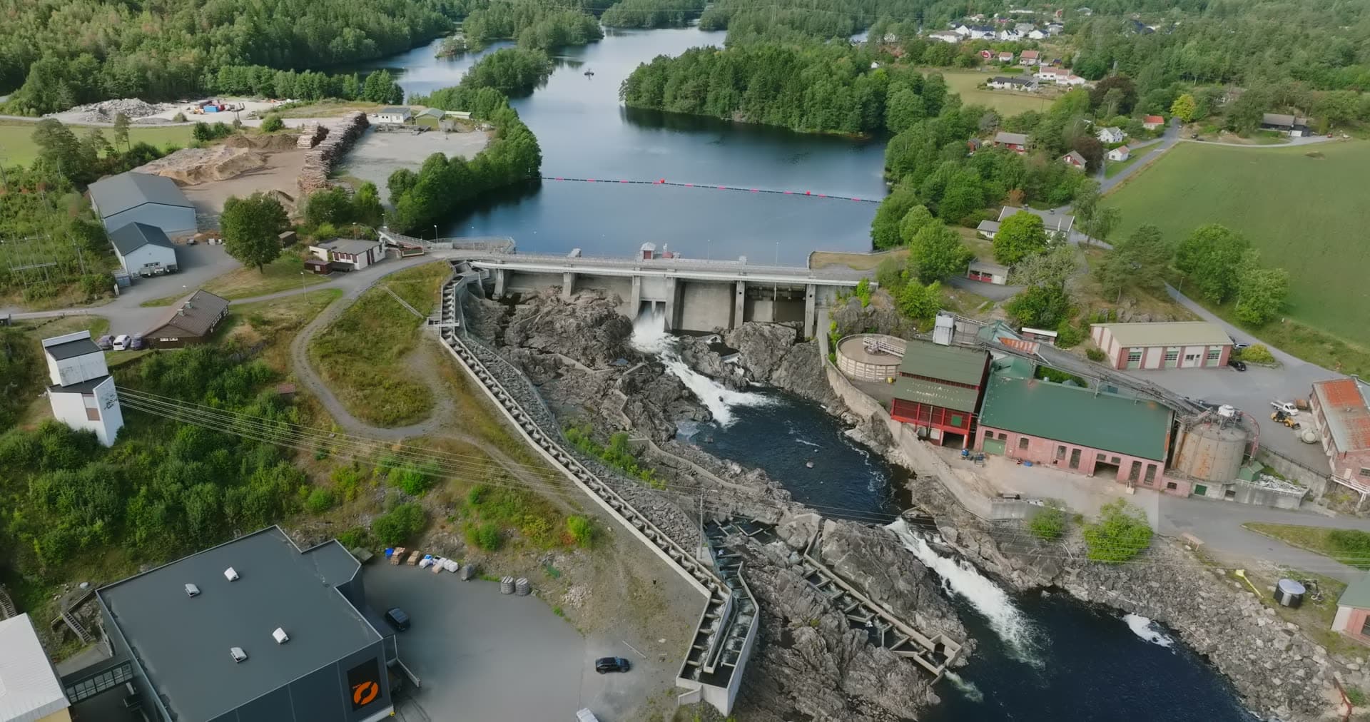 Concrete dam spilling into rocky river gorge, Rykene, Norway