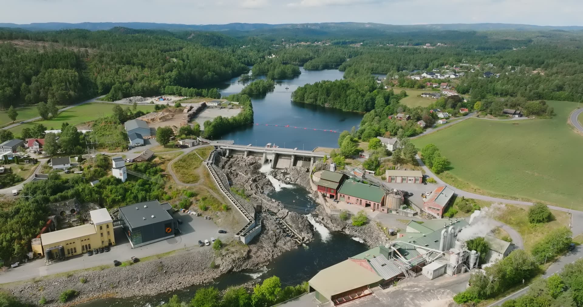 River dam and gates below a boom line, Rykene, Norway