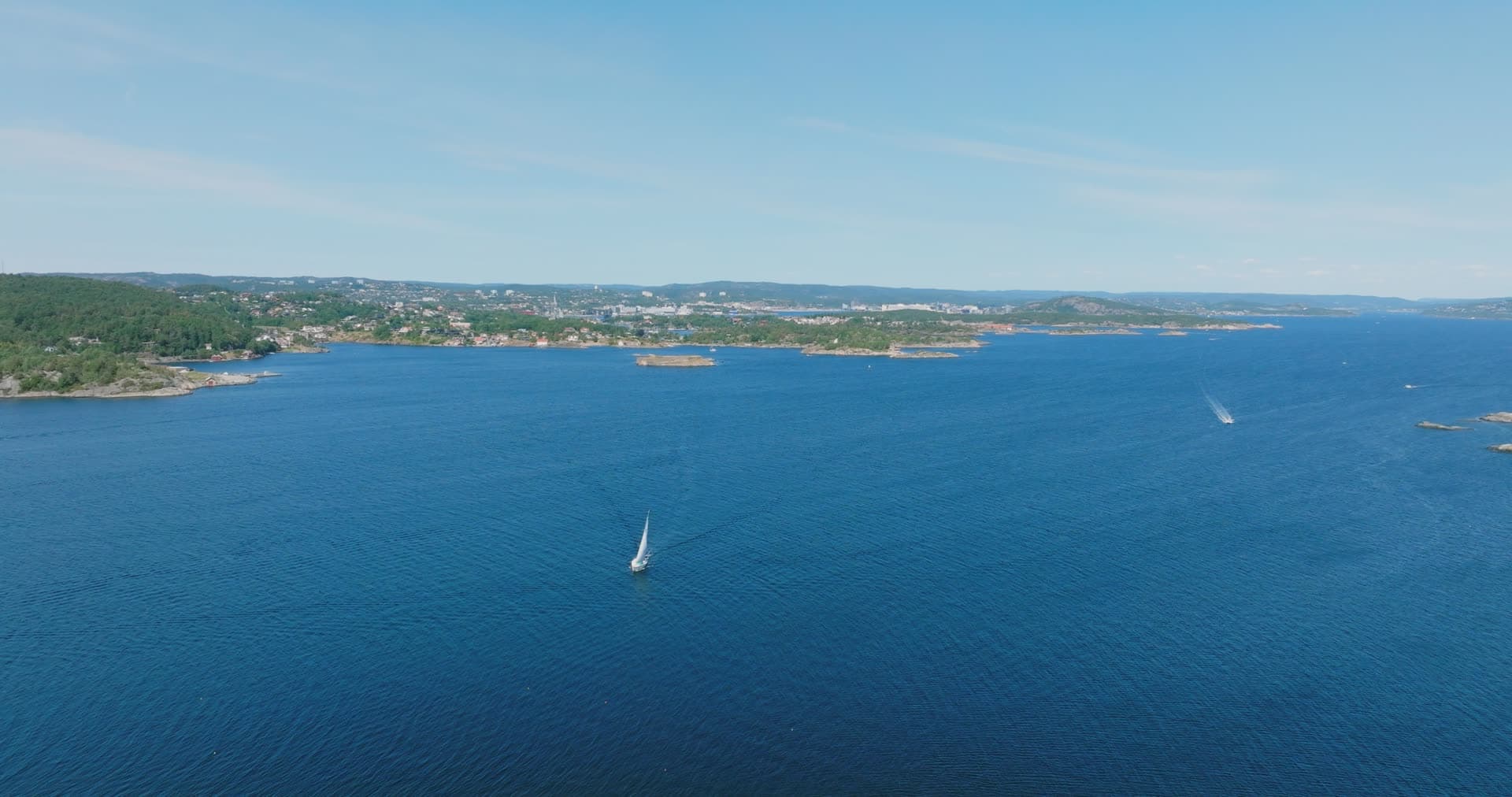 Chain of bare skerries below the coastal town, Skålevik, Norway