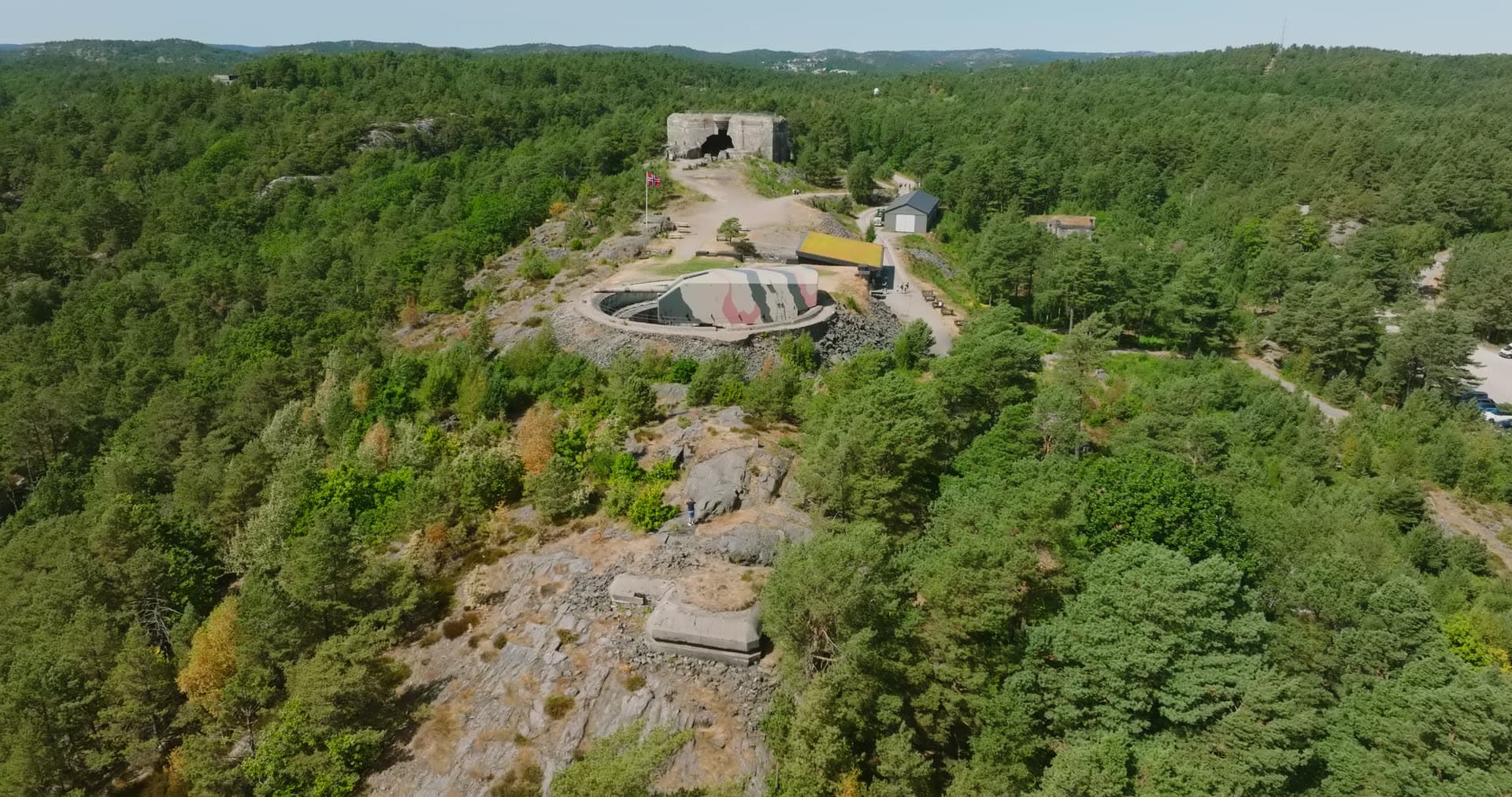Norwegian flag over the camouflaged gun turret, Møvik, Norway
