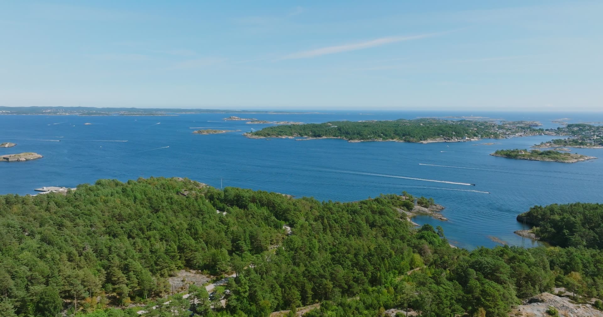 Open sea beyond a pine-covered headland, Møvik, Norway