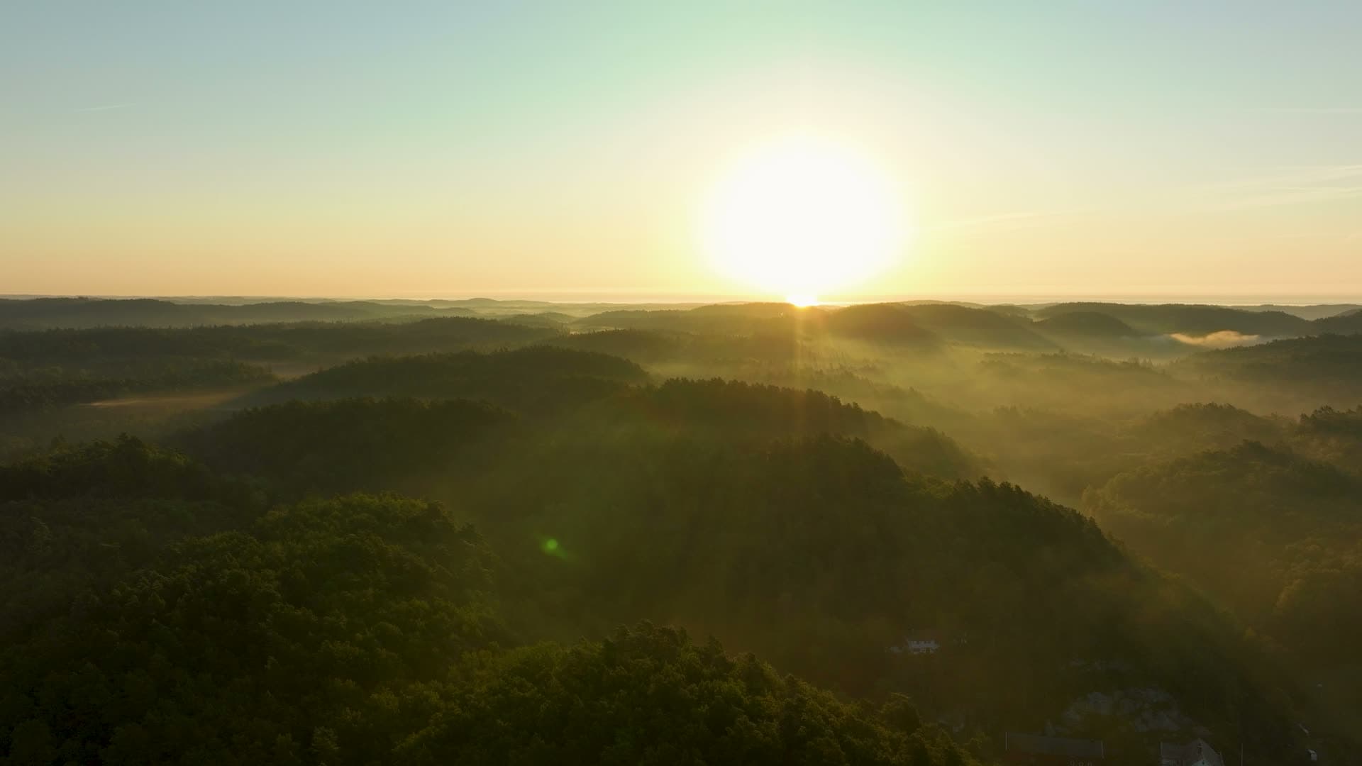 Sunrise over mist-filled forested ridges, Søm, Norway
