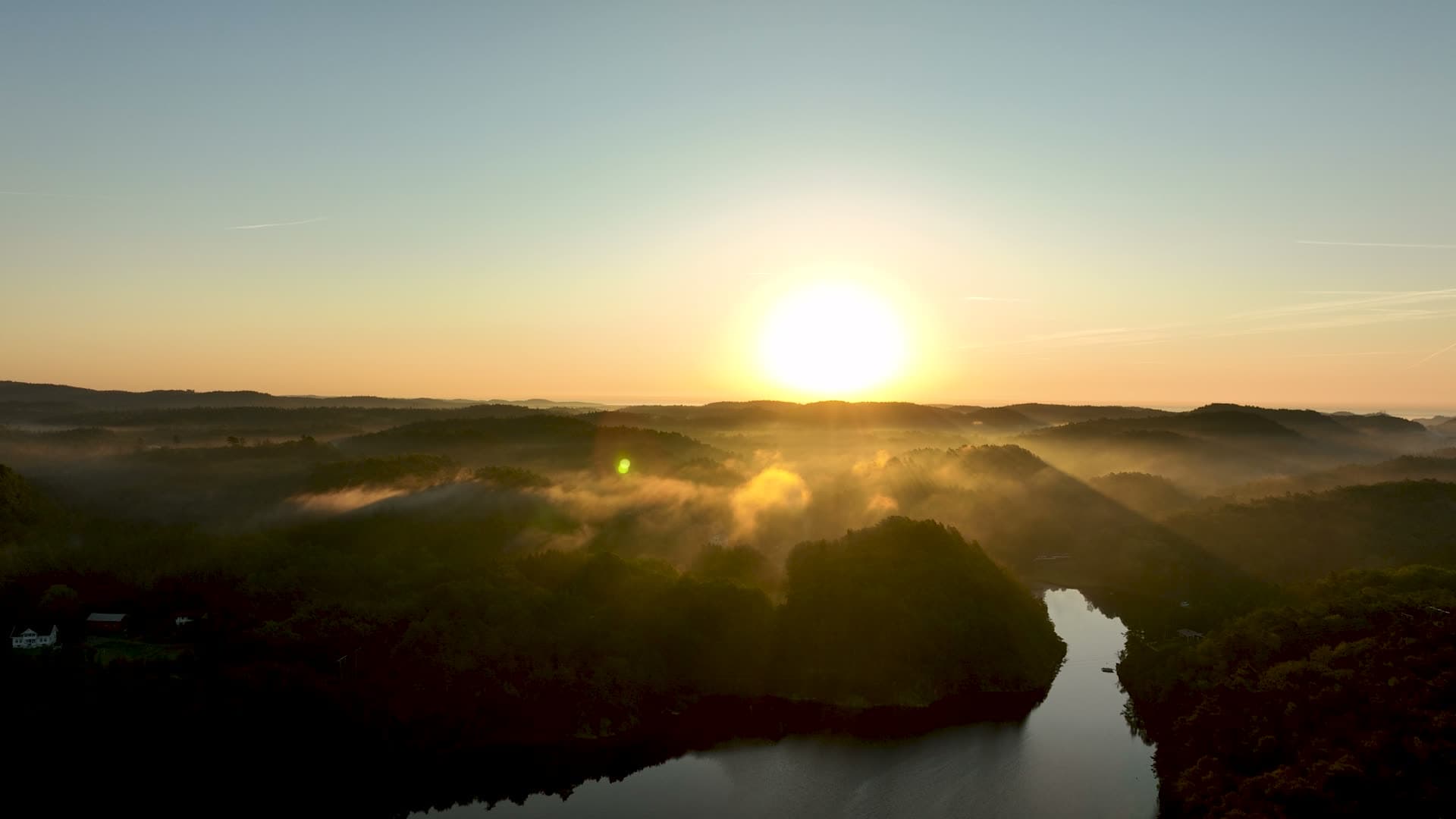 Sun over mist-filled valley and narrow inlet, Søm, Norway