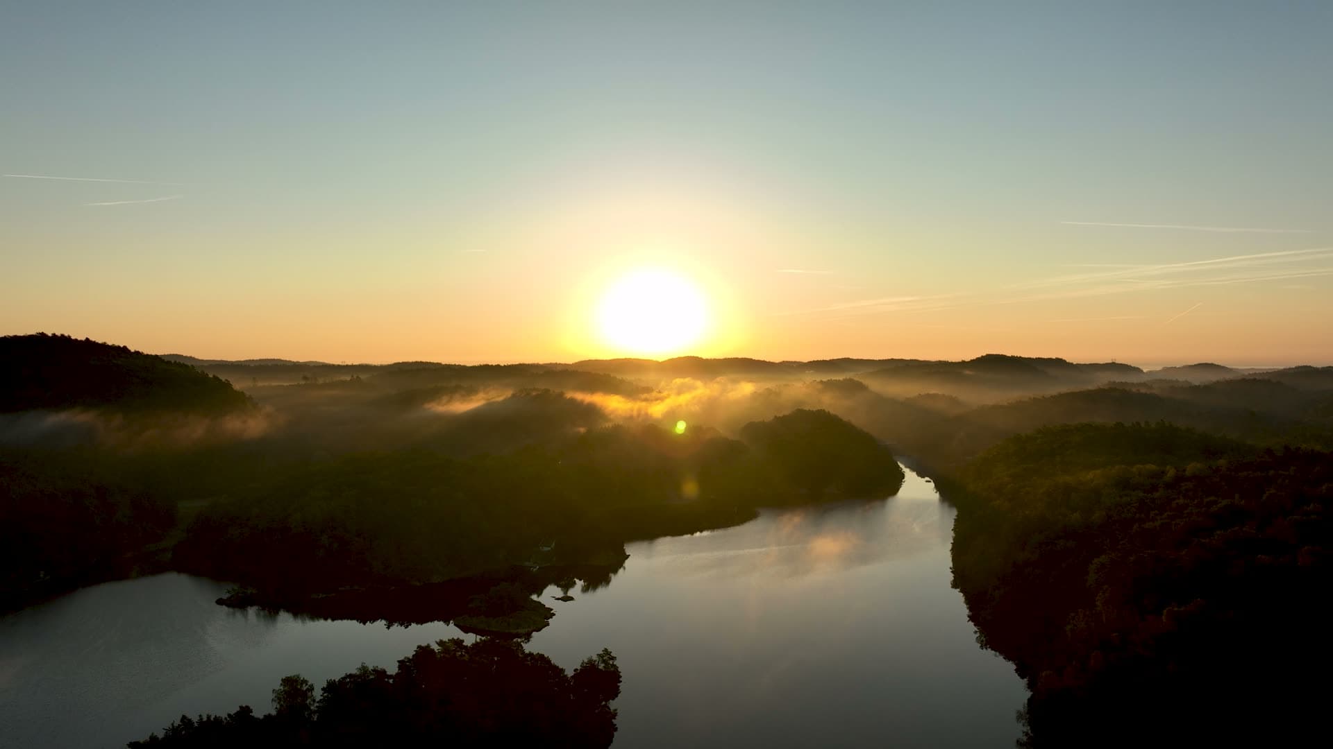 Sunrise over misty forest lake inlet, Søm, Norway