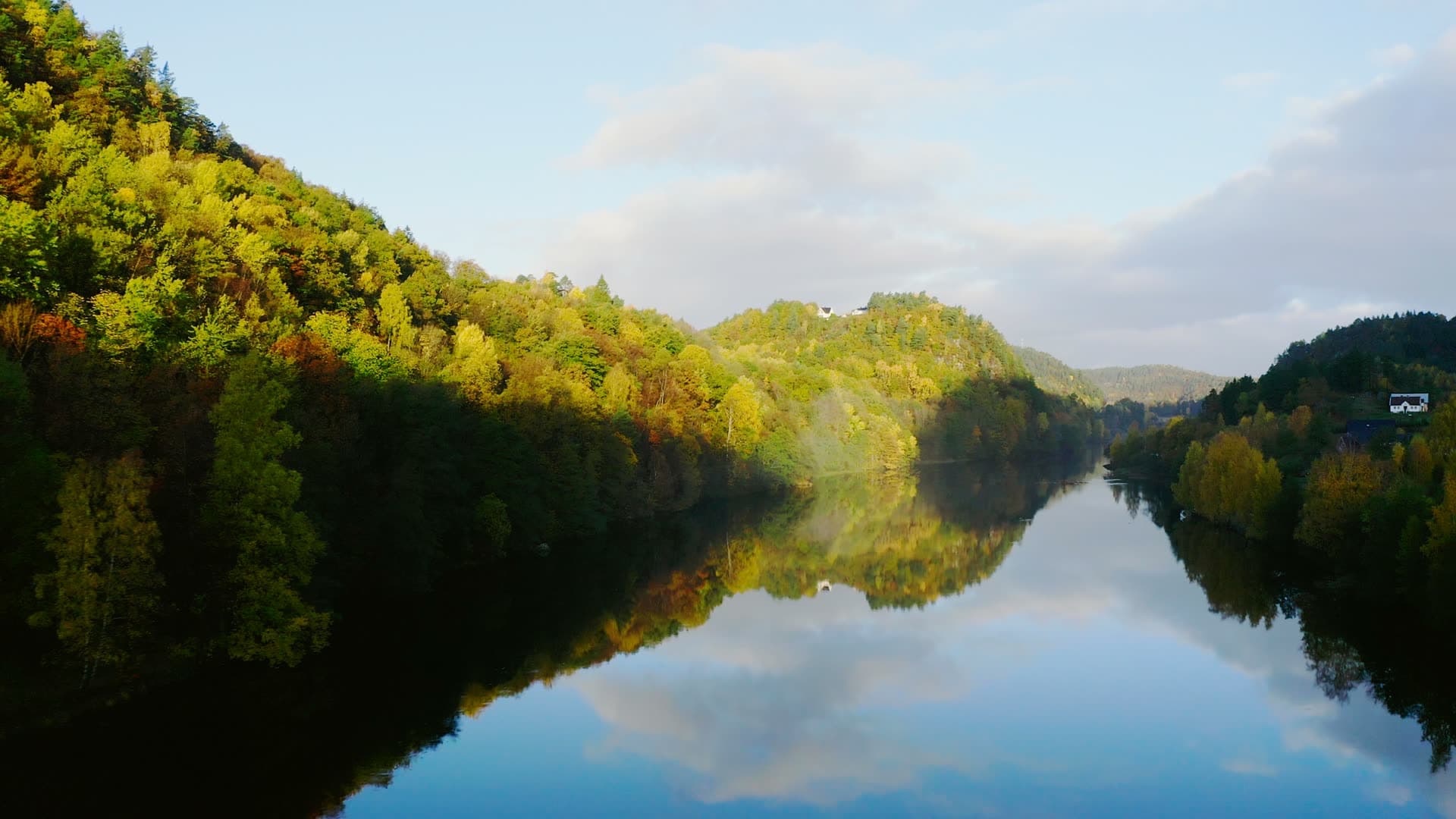 Mirror-calm river between autumn hillsides, Strai, Norway
