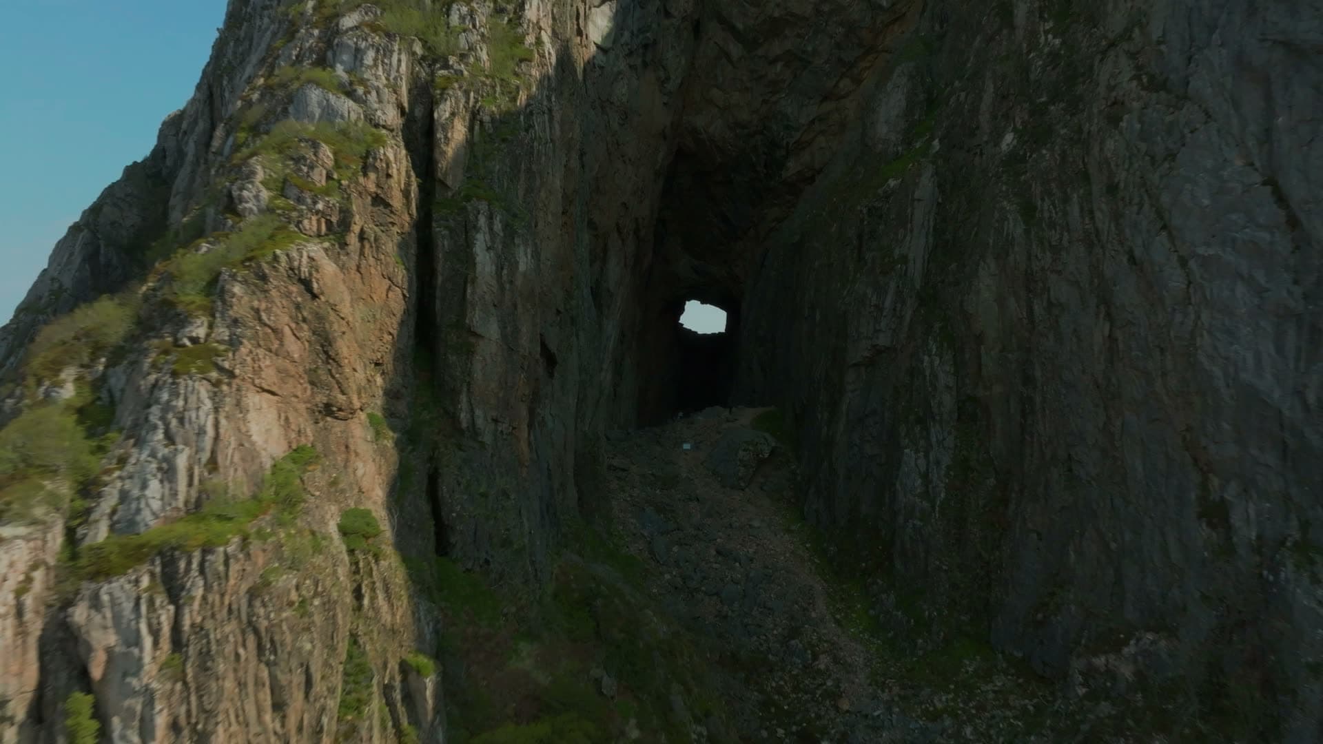 Flight into cliff tunnel toward light, Torghatten, Norway