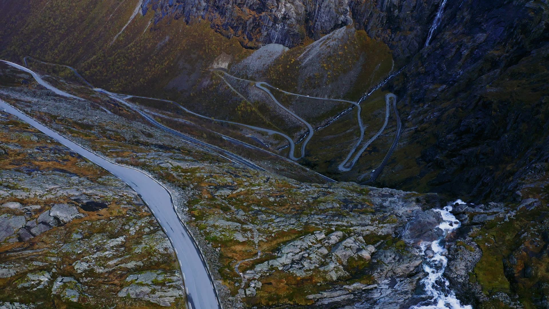 Hairpin mountain road above waterfall gorge, Trollstigen, Norway