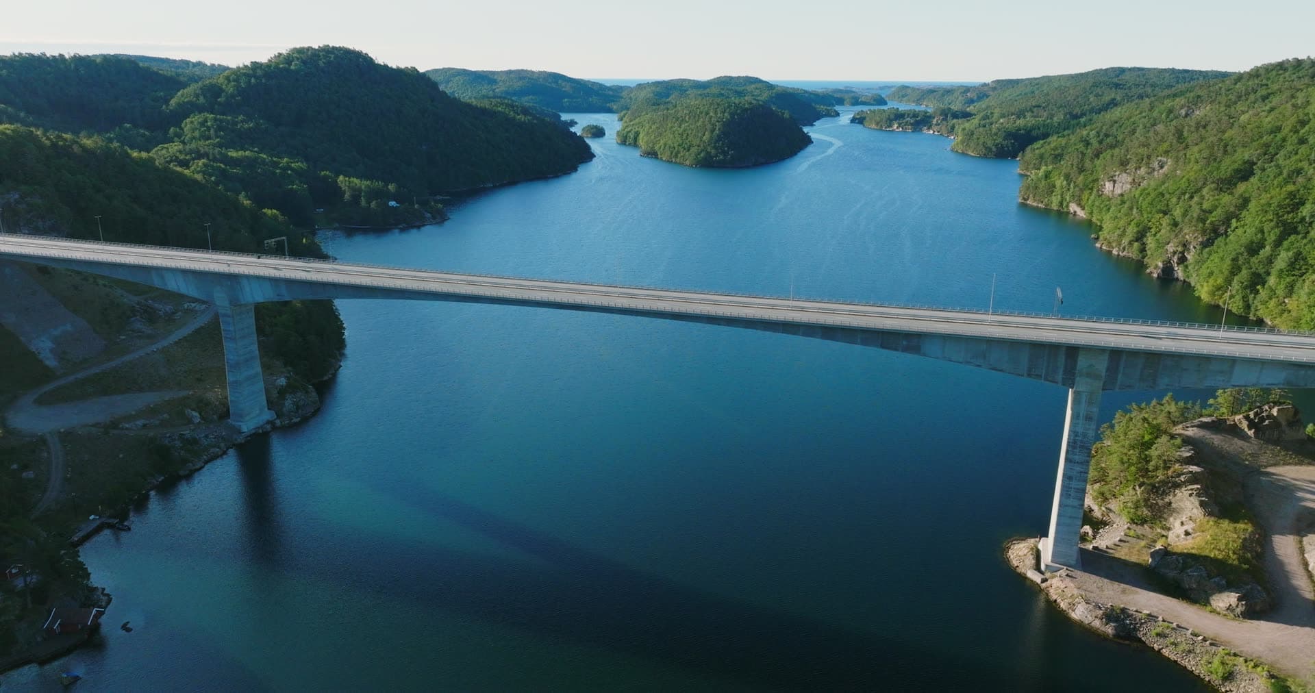 Wooded islets recede past bridge deck, Trysfjordbrua, Norway