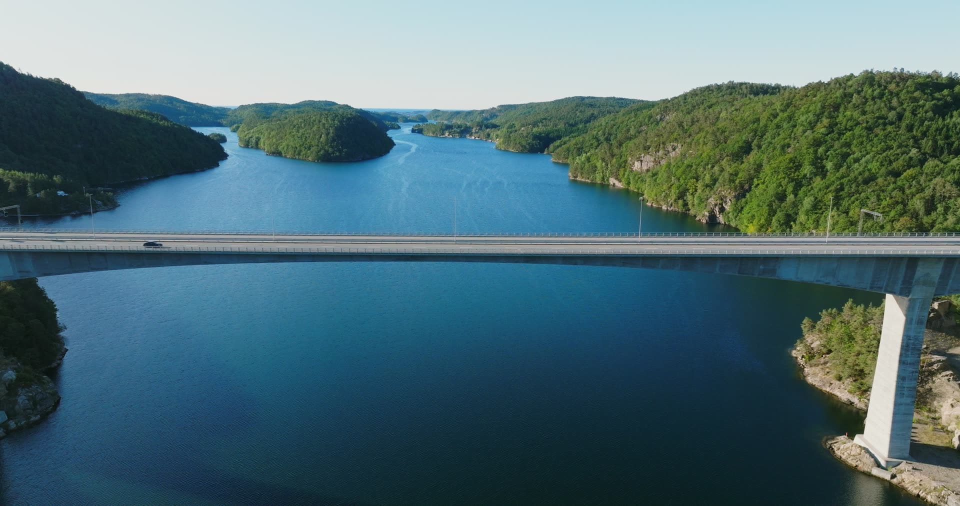 Car crossing high concrete fjord bridge, Trysfjordbrua, Norway