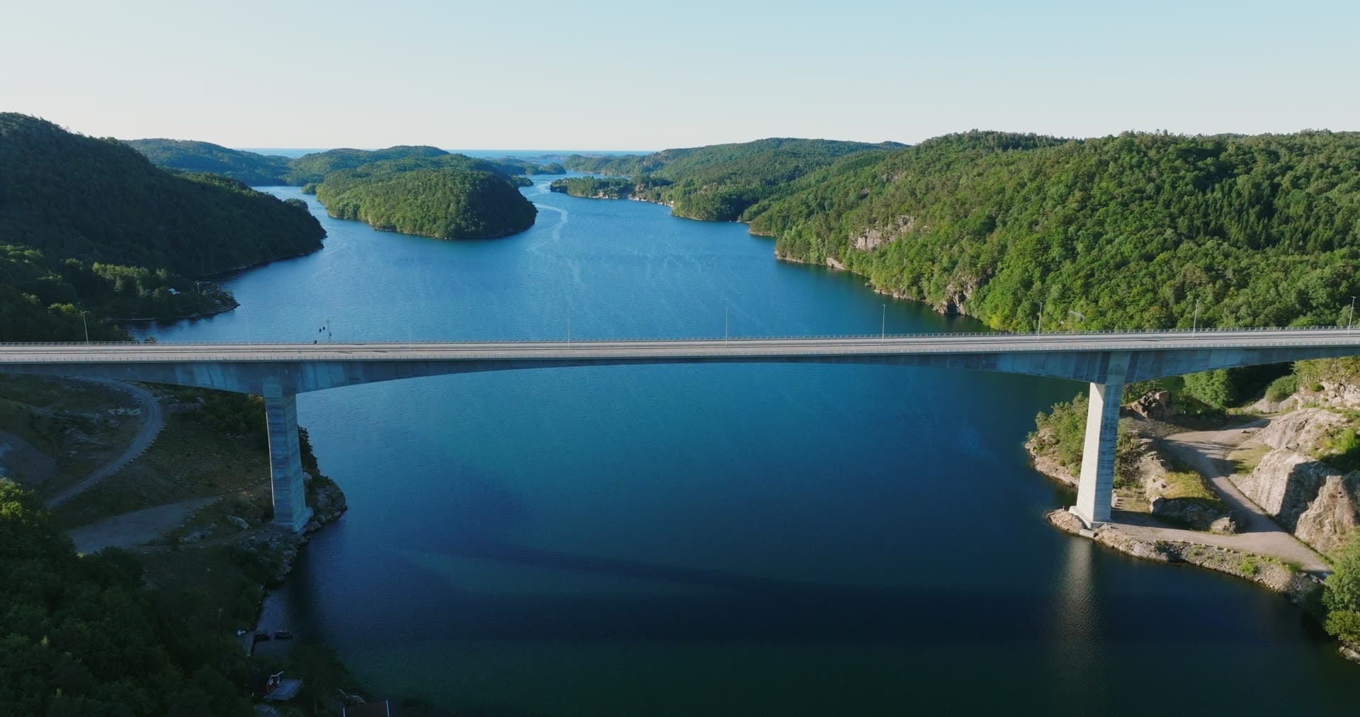 Bridge shadow on dark water, pull back, Trysfjordbrua, Norway