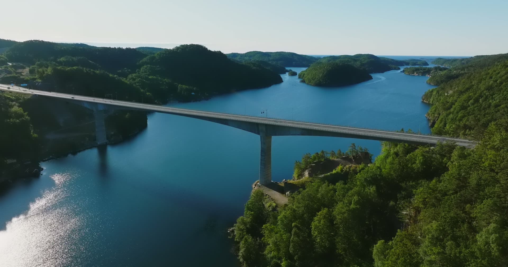 Climb over spruce tops to bridge span, Trysfjordbrua, Norway