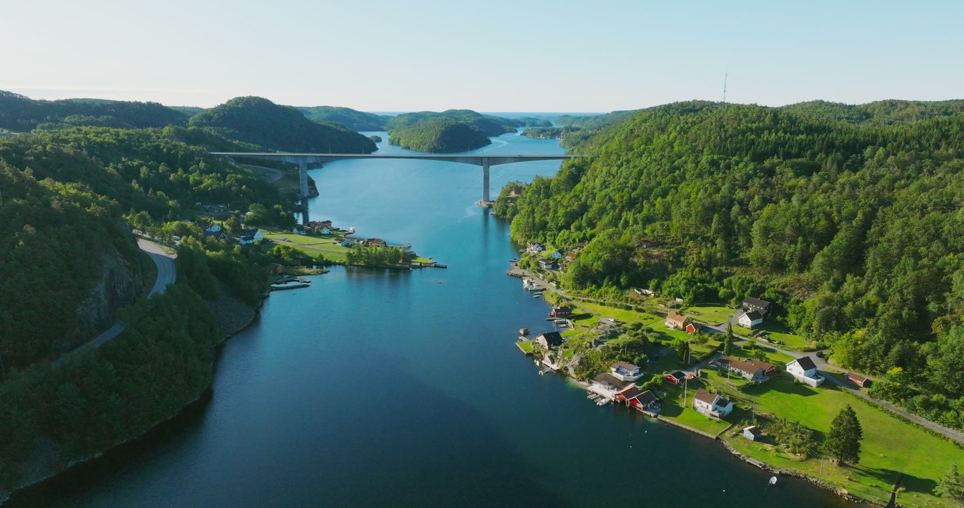 Highway bridge over fjord past red houses, Trysfjordbrua, Norway