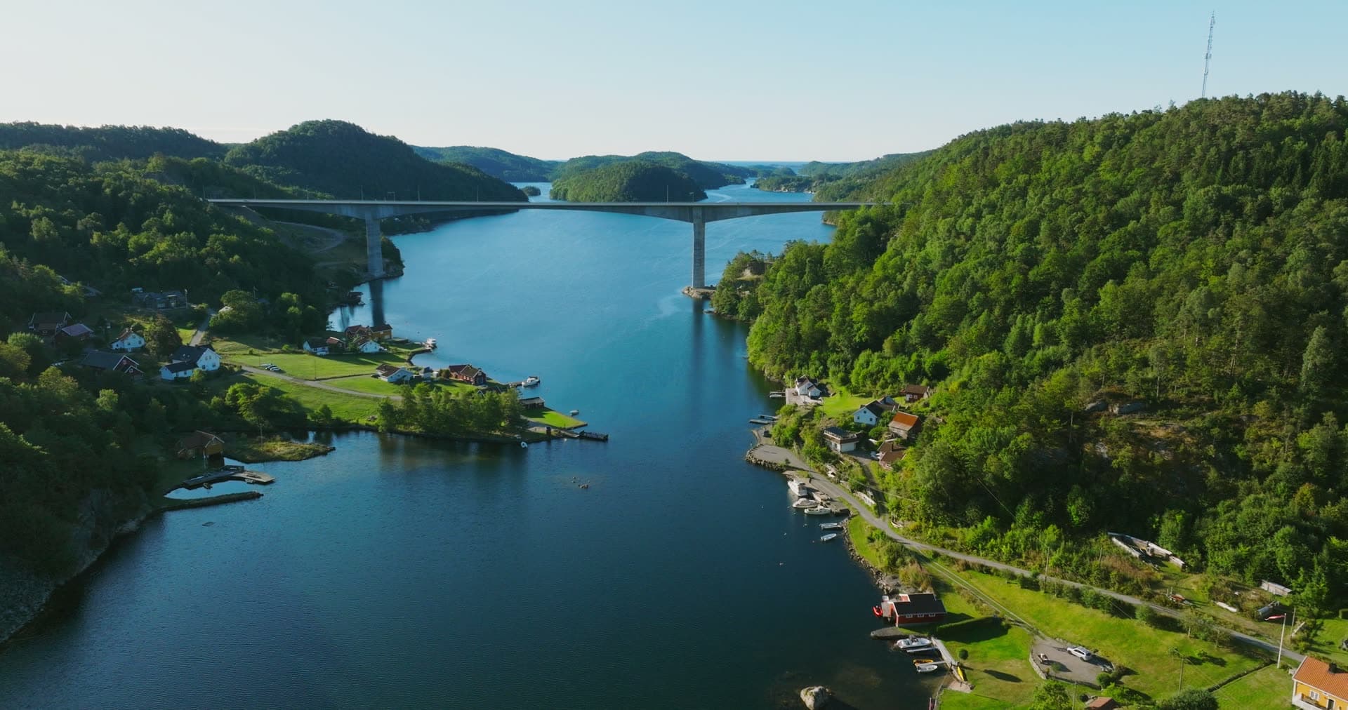 High bridge over fjord past shore houses, Trysfjordbrua, Norway