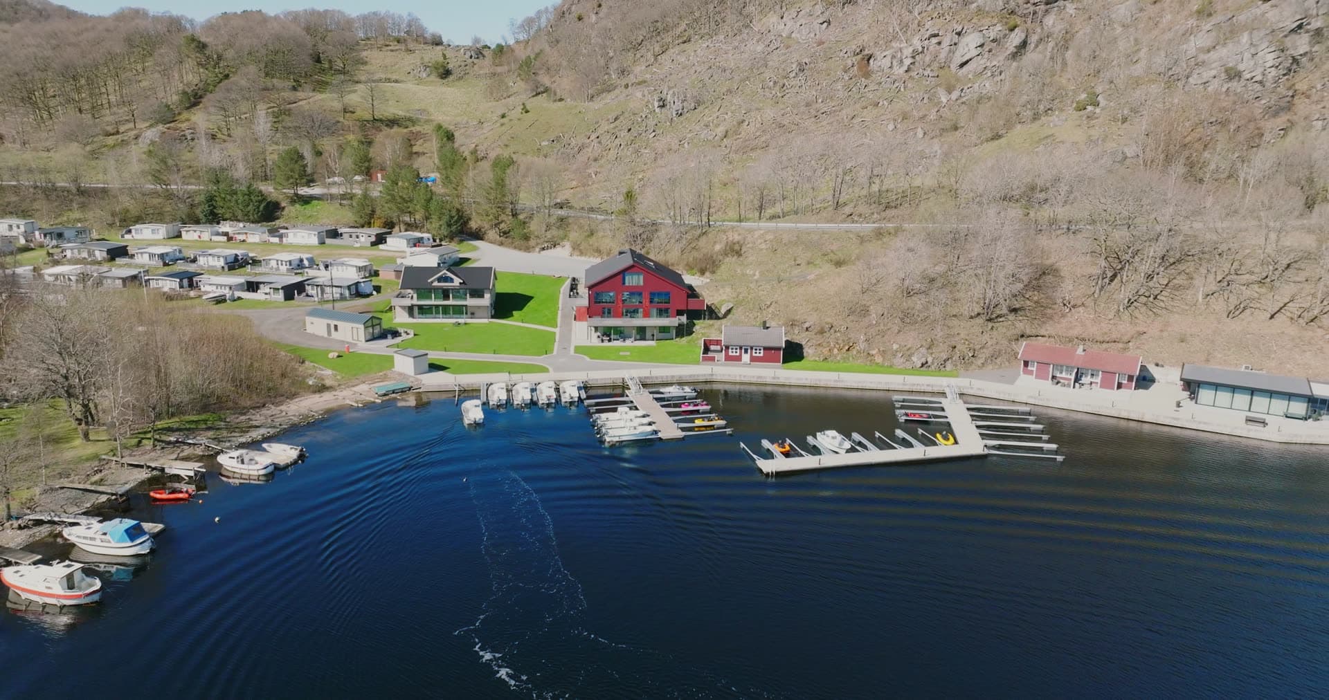 Small marina and cabin park below cliff, Vanse, Norway