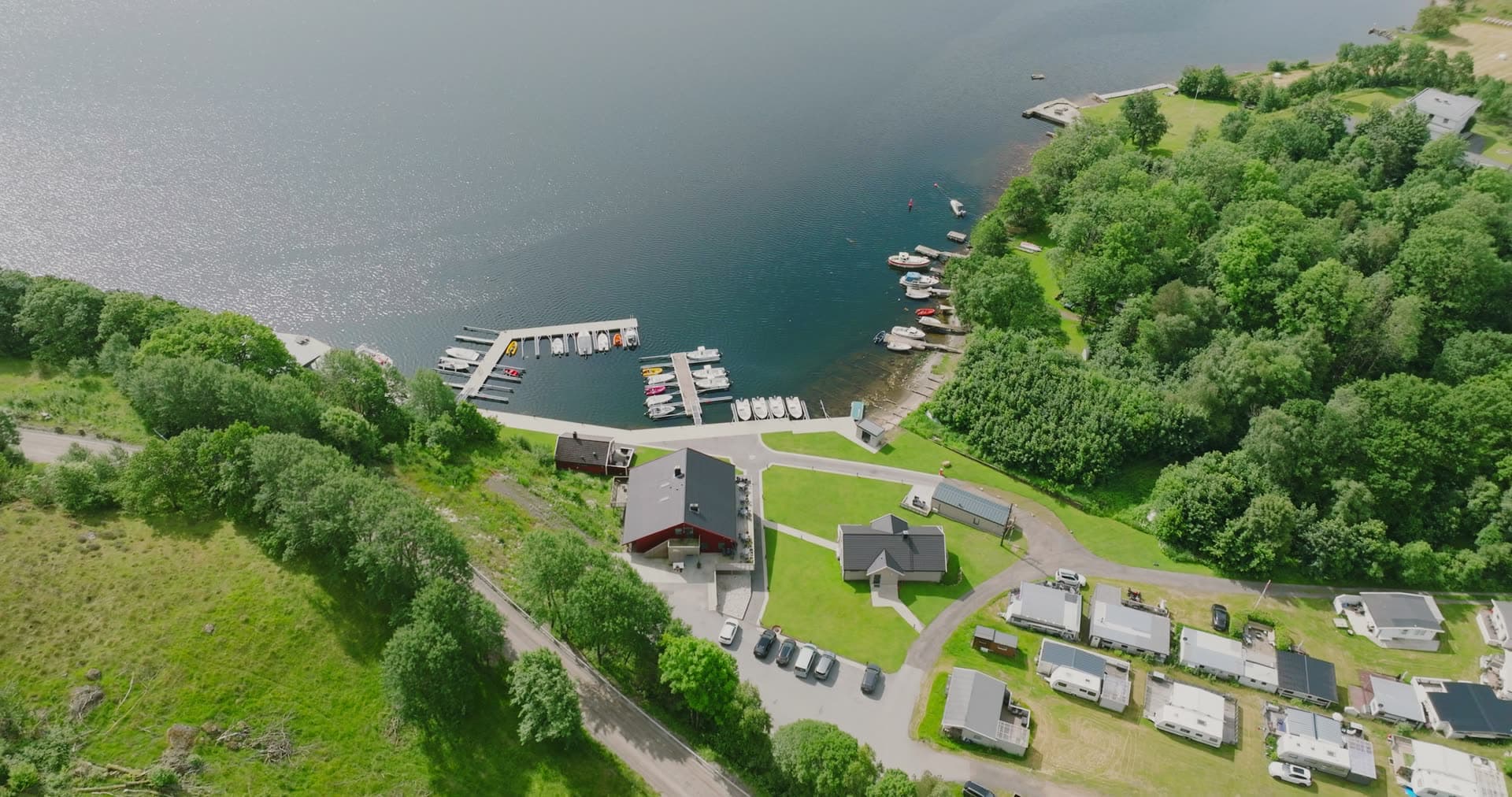 Small marina beside caravan park on lake, Vanse, Norway