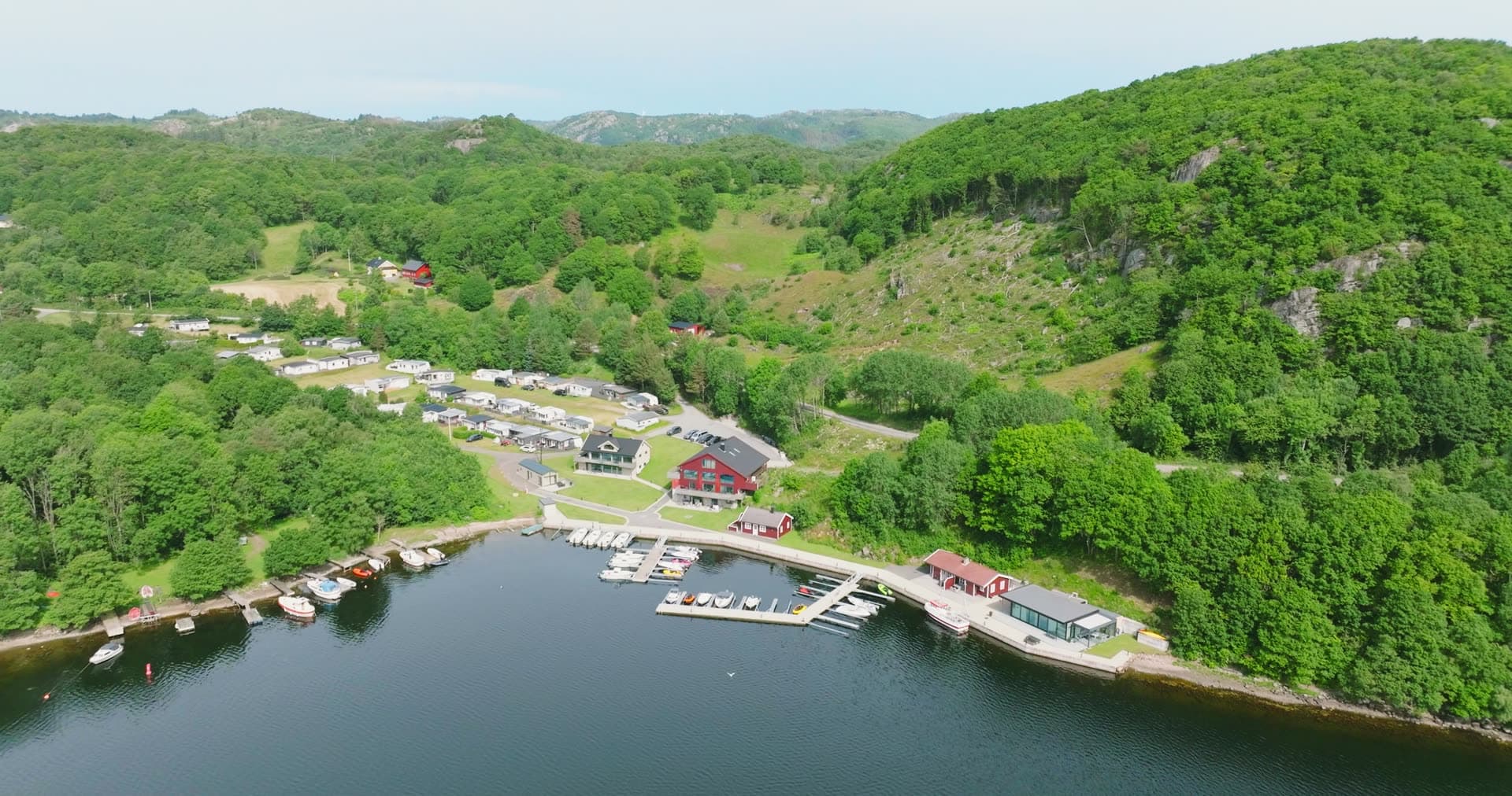 Caravan park and marina docks below hill, Vanse, Norway