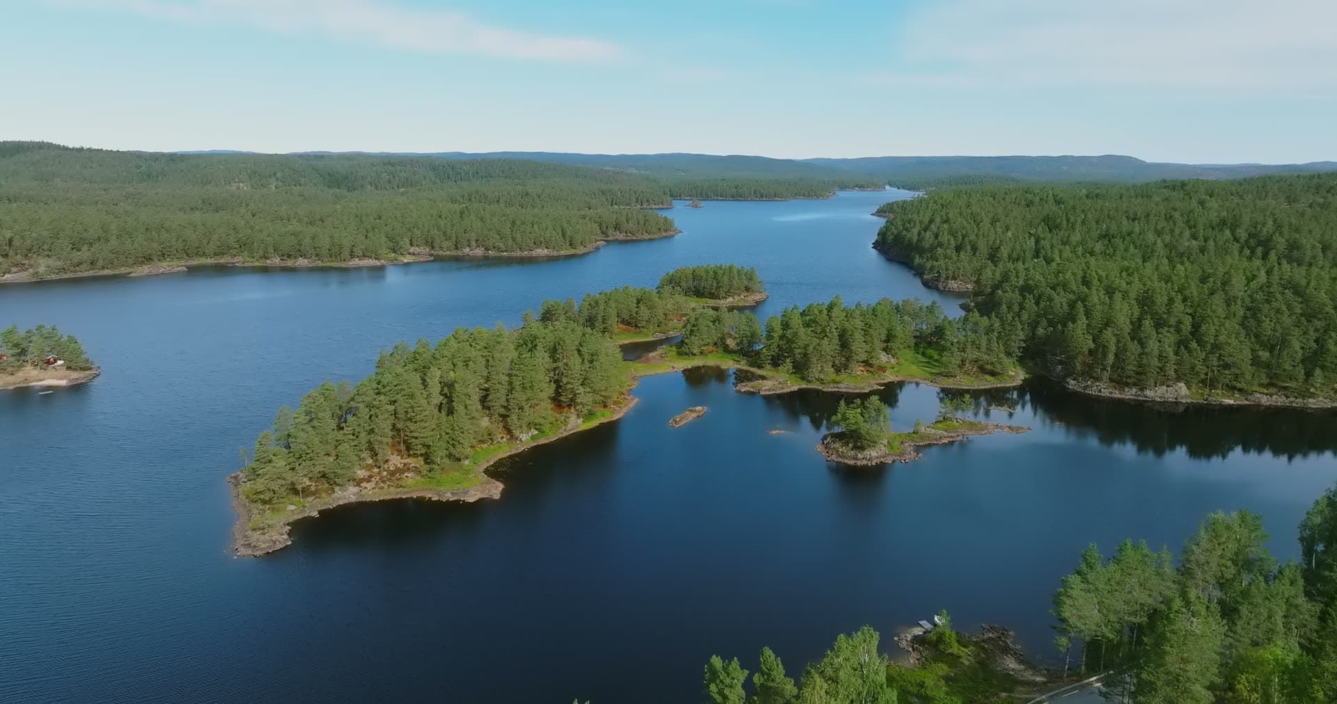 Chain of skerries toward distant ridges, Vassbotn, Norway