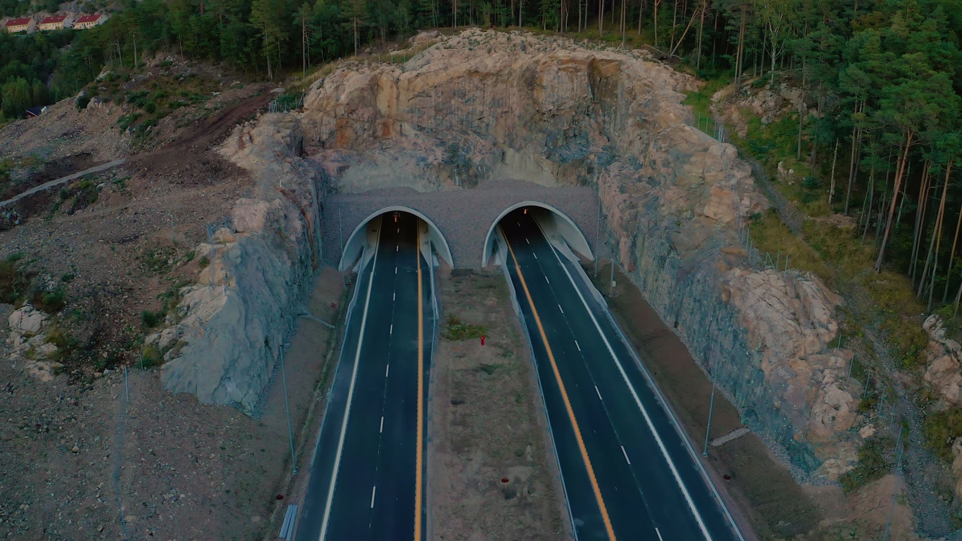 Twin tunnel portals in blasted rock face, Vedderheia, Norway