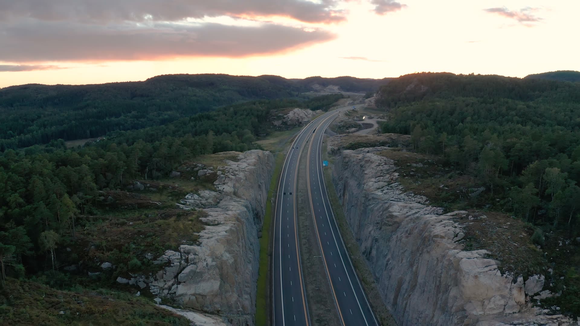 Motorway in blasted rock cut at sunset, Vedderheia, Norway