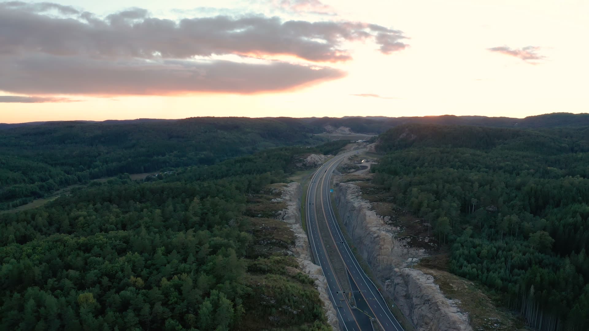 New motorway in rock cutting at sunset, Vedderheia, Norway