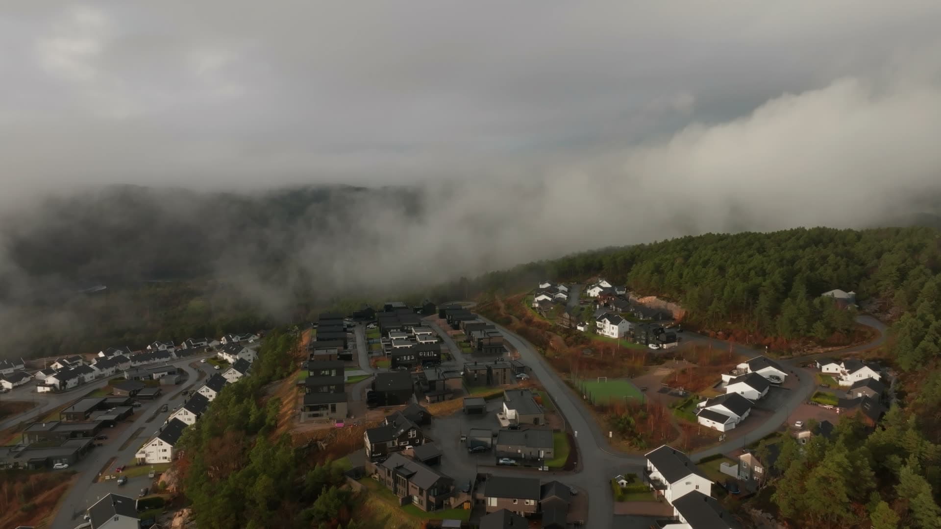 Green artificial turf pitch between houses, Vedderheia, Norway