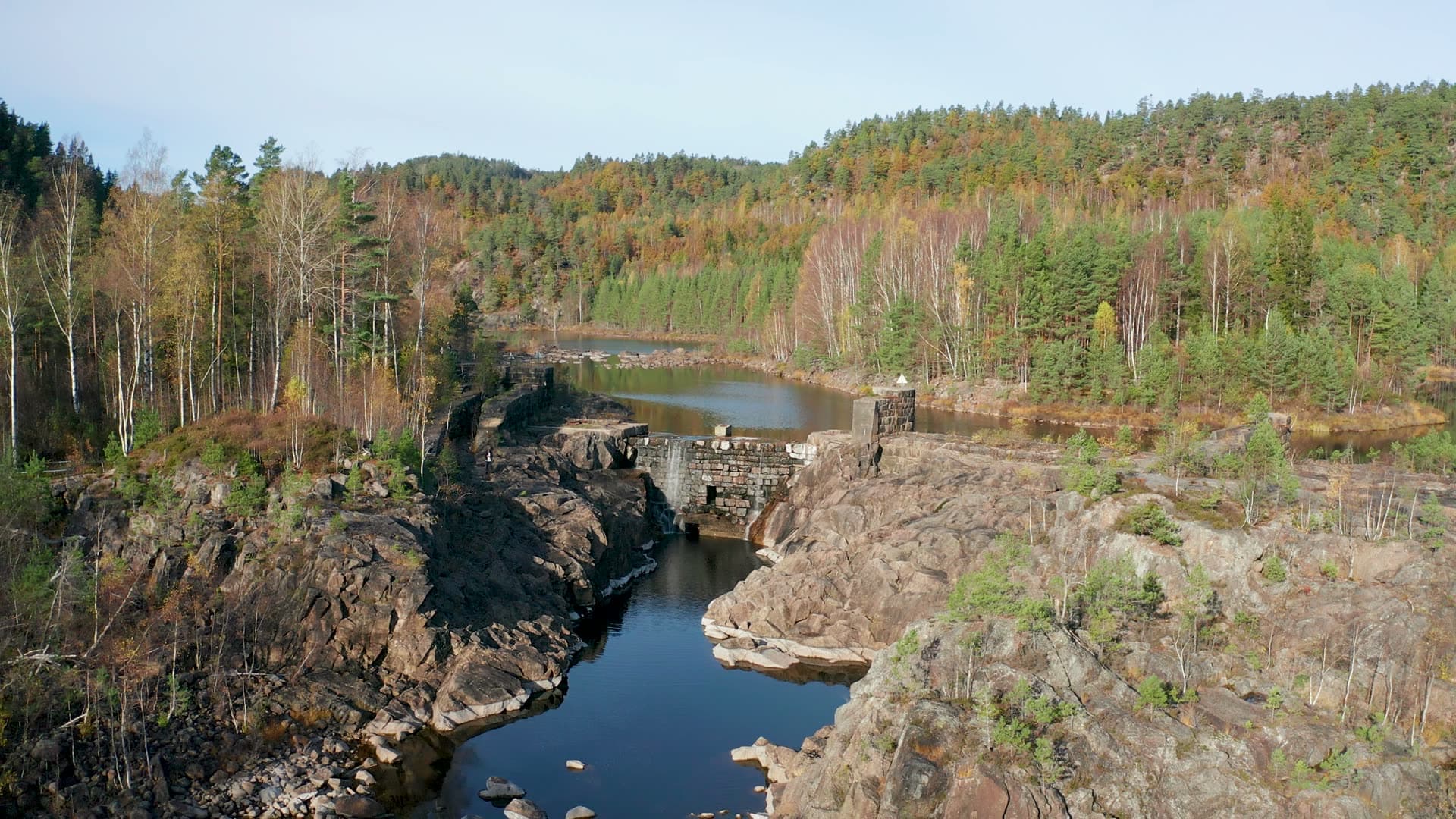 Old stone dam in rocky river gorge, Vennesla, Norway
