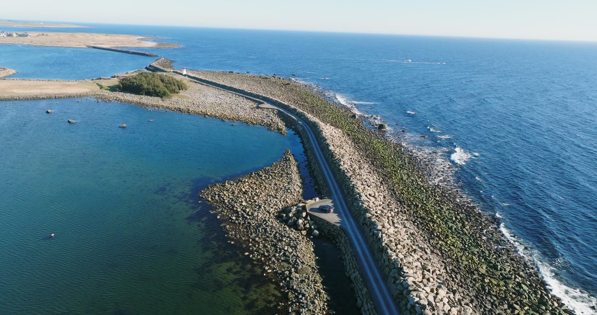 Road on boulder causeway between sea and lagoon, Vestbygd, Norway