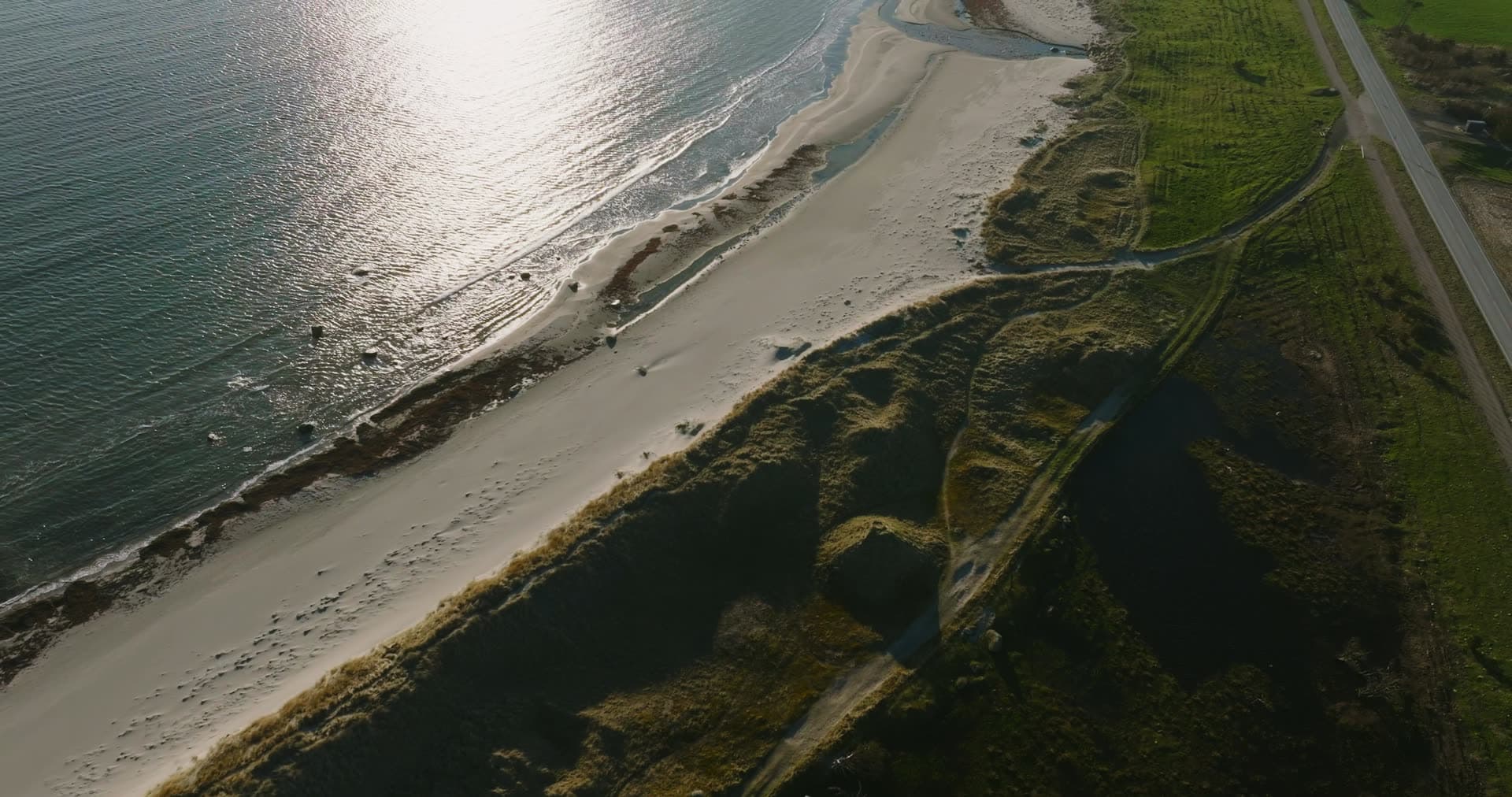 Sand beach and dunes beside a road, Vestbygd, Norway