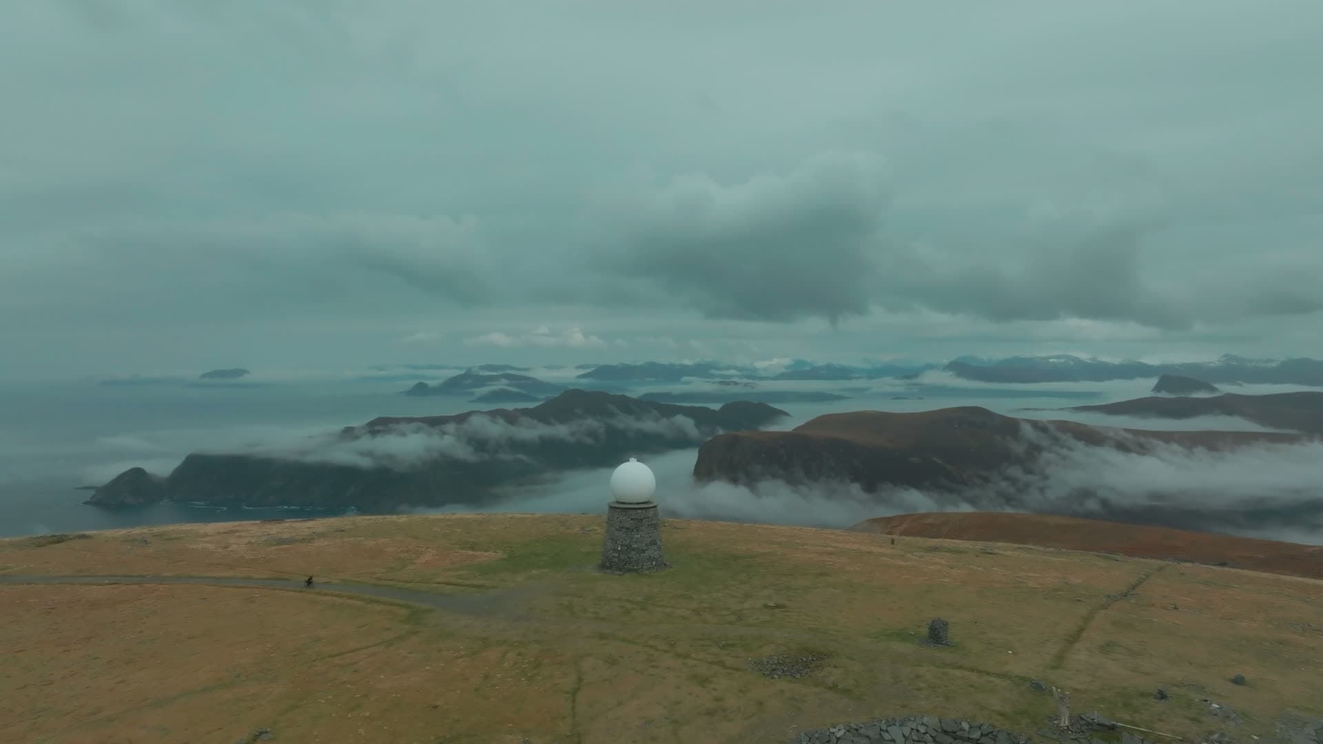 Radar dome on plateau above cloud layer, Vestkapp, Norway